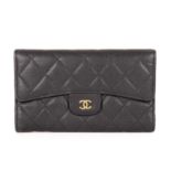 Chanel, a quilted wallet, featuring a diamond quilted black caviar leather exterior, with a rear