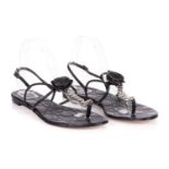 Christian Dior, a pair of unworn black leather thong sandals, featuring a leather central rosette,