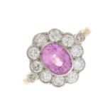 An 18ct gold and platinum pink sapphire and diamond cluster ring
