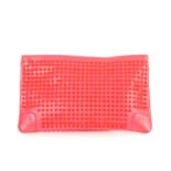 Christian Louboutin, a studded Loubiposh clutch, crafted from fluorescent pink patent leather,