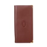 Cartier, a long Bordeaux Bifold wallet, crafted from smooth burgundy leather, featuring the maker'