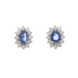 A pair of gold, sapphire and diamond cluster stud earrings