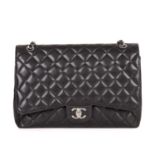 Chanel, a Maxi Classic Double Flap handbag, featuring the maker's signature black quilted caviar