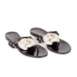 Chanel, a pair of unworn rubber Camellia thong sandals, crafted from black rubber, featuring a large