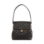Chanel, a tall Double Sided Classic Flap handbag, featuring the maker's signature diamond quilted