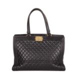 Chanel, a Boy tote, designed with a black diamond quilted leather exterior with ribbed leather trim,