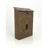 An Arts and Crafts copper letter box, repousse embossed with hobnail studs, applied fretted