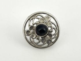 Keswick School Industrial Art, an Arts and Crafts silver garnet set brooch, circular form,