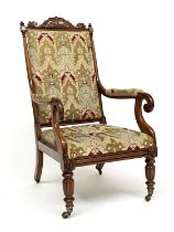 A William IV Rosewood library armchair, circa 1830, acanthus scroll pediment and finials to the