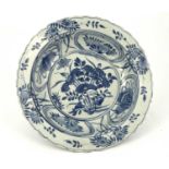 An Oriental blue and white bowl, painted with a crane and foliage within an ogee cartouche border