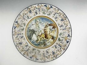A pair of majolica chargers, early 20th century painted with mytholigical scenes within caryatid and