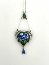 Charles Horner, an Arts and Crafts silver pendant, convex cartouche form with relief moulded tendril
