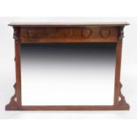 LIberty & Co, an Arts and Crafts walnut overmantel mirror, the frieze carved with heart motifs,