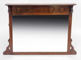 LIberty & Co, an Arts and Crafts walnut overmantel mirror, the frieze carved with heart motifs,