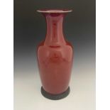 A large Chinese monochrome high fired vase, baluster form, purple sang de boeuf glaze, fixed to