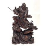 A large Chinese carved hardwood figure, modelled as a warrior with spear and dragon, 91cm high