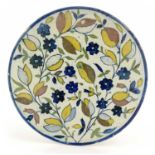 An Islamic pottery plate, possibly 16th century or later, shallow dished form, painted with