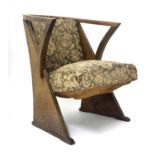 An Arts & Crafts oak armchair, circa 1910, curved back, downswept arms with inverted supports,