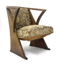 An Arts & Crafts oak armchair, circa 1910, curved back, downswept arms with inverted supports,