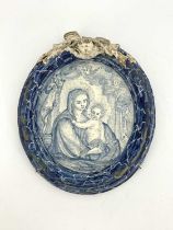 A French faience blue and white plaque, 19th century or earlier, painted with an image of the Virgin