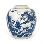 A Chinese blue and white ginger jar, Qing, painted in the round with two dragons emerging from