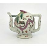A Chinese famille rose wine pot, in the form of a peach, filling hole to the underside, painted with