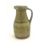 Richard Batterham (British, 1936-2021), a large jug, double spout, ribbed handle, green ash glaze,