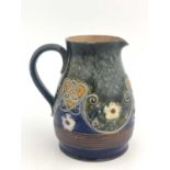 A Royal Doulton stoneware jug, circa 1910, relief moulded with flowerheads and scroll design, 17cm