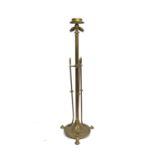 An Arts and Crafts brass floor standing lamp in the style of the Birmingham Guild, three flying