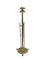 An Arts and Crafts brass floor standing lamp in the style of the Birmingham Guild, three flying