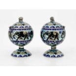 A pair of champlevee enamelled pedestal silver salt cellars, spherical bodies with hinged lids,