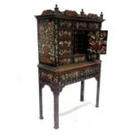 A Dutch ebony marquetry inlaid cabinet on stand, late 17th/18th Century and later, florally inlaid