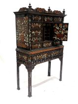 A Dutch ebony marquetry inlaid cabinet on stand, late 17th/18th Century and later, florally inlaid