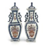 A pair of Chinese famille rose twin handled vases and covers, 18th century, square section