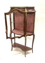 A kingwood vitrine of Louis XVI design, 20th Century, of serpentine form with cast brass gallery and