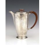 Arthur Edward Harvey for Adie Brothers, an Art Deco silver lidded jug, Birmingham 1935, footed