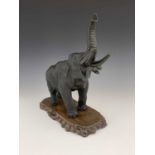 A Japanese bronze figure of an elephant, Meiji period, modelled with trunk raised, cast seal