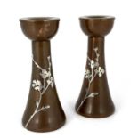 Heintz, a pair of Arts and Crasts silver overlay copper candlesticks, model 3105, trumped form