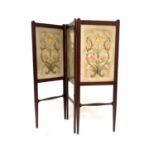 An Arts and Crafts walnut embroidered three fold screen, probably Morris and Co., in the style of