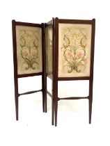 An Arts and Crafts walnut embroidered three fold screen, probably Morris and Co., in the style of