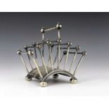 Christopher Dresser for Hukin and Heath, a silver plated six division toast rack, circa 1881,