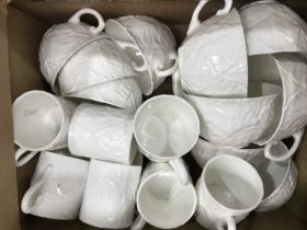 Wedgwood Countryware white glazed coffee cups and tea cups, leaf moulded decoration.