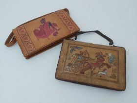 Two 1940s embossed leather messenger hand bags, Egyptian hieroglyphic and Indian designs,