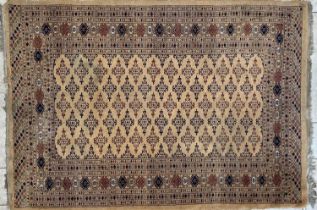 An oriental rug, black and rust geometric design on a gold ground, 185cm by 130cm