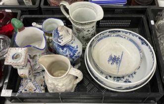 A quantity of 19th century and later moulded jugs and bowls, including a religious Prattware jug,