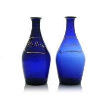 A matched pair of Bristol blue glass decanters, circa 1790, Indian club form, decorated with painted