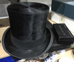 A vintage black silk top hat, maker Herbert Johnson, London, in cardboard box with a hat polishing