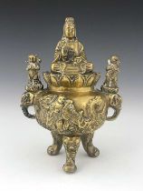 An Oriental bronze censer, modelled in relief with a figure on a dragon to each side, the lid with