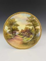 R. Rushton for Royal Worcester, a cottage painted cabinet plate, gilt border, printed mark, 28cm