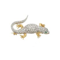 An 18ct bi-colour gold diamond and emerald lizard brooch